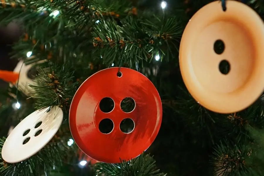 Tăng vẻ đẹp cho cây thông Noel với chi tiết trang trí từ cúc áo nhiều màu sắc.