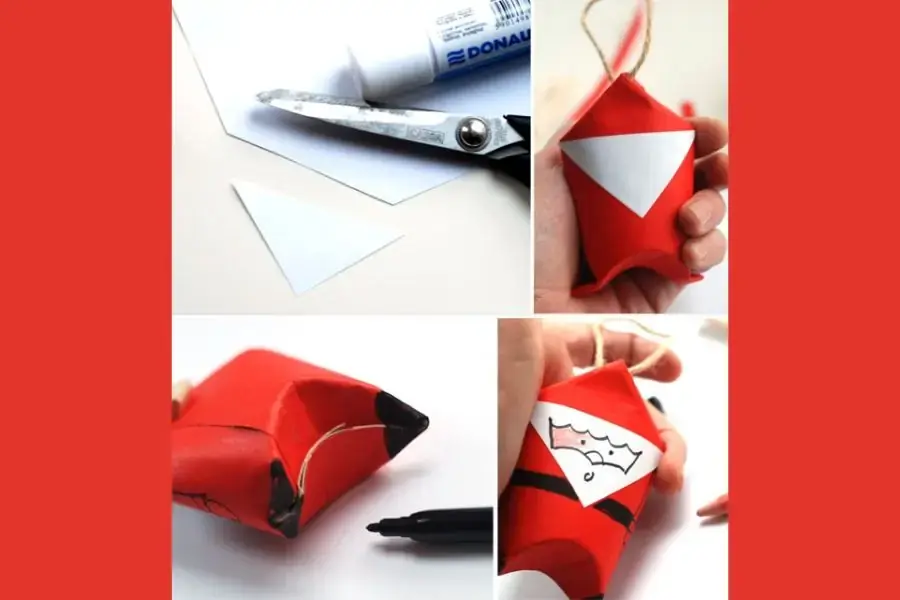 Vẽ mặt cho ông già Noel bằng bút dạ đen.