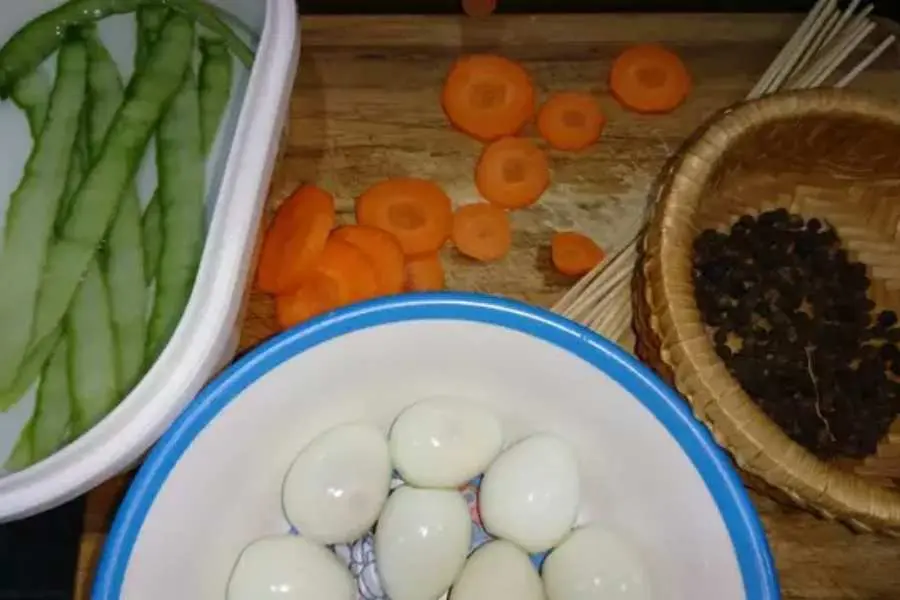 Lột vỏ trứng cút và sơ chế các nguyên liệu khác để tiến hành tạo hình người tuyết.