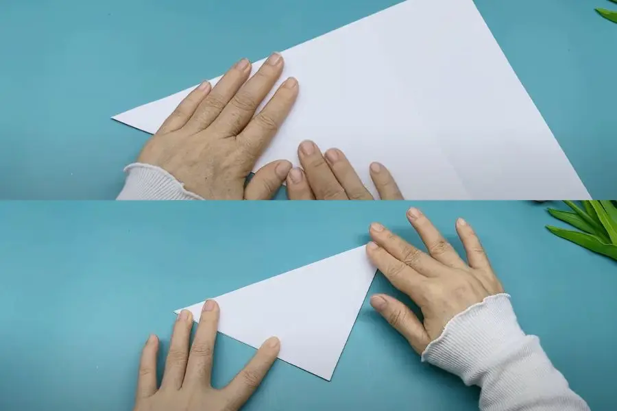 Gấp đôi giấy A4 rồi cắt ra thành hình tam giác.