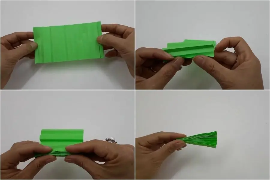 Bạn xếp tờ giấy vào từng tầng theo nếp đã tạo ở bước 1.